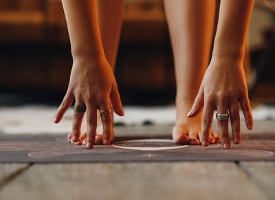 Close-up of feet on a yoga mat during a fluid movement.